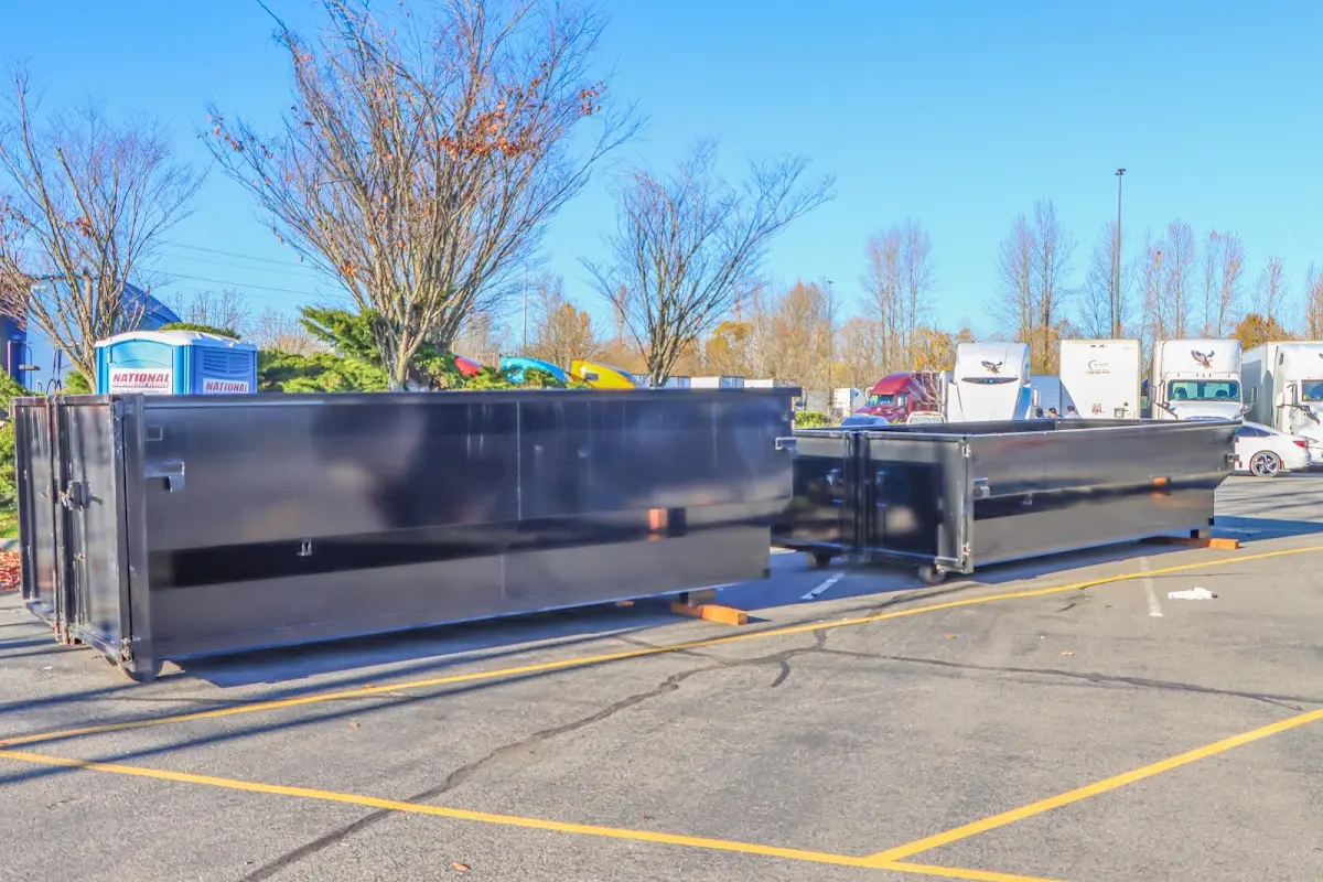 Professional dumpster rental service with roll-off container on residential driveway in Gig Harbor